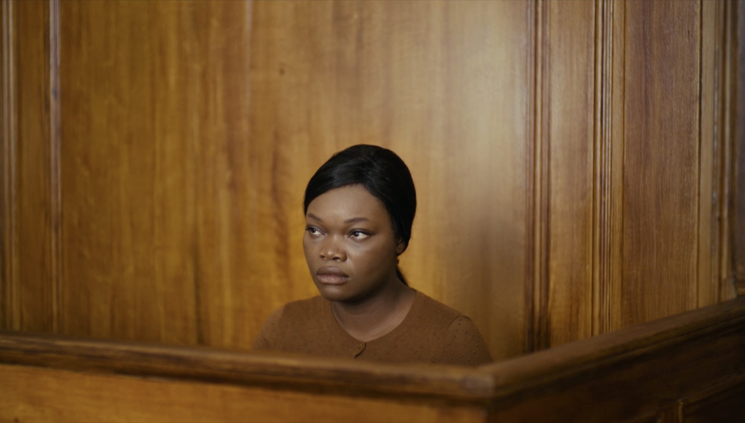 Woman against a huge wooden wall