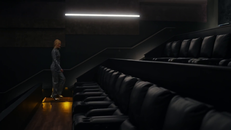 She ascends the stairs, presumably looking for a seat. We now see that the theater is empty – there's nobody else there. A wasteland of empty seats. I sure hope someone creates a very good commercial and makes people want to go to the movies again!